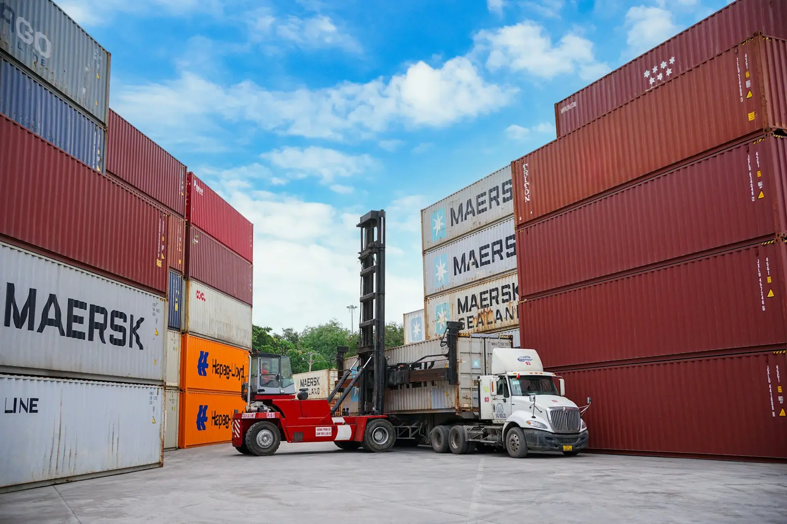 A truck loading a container at a port container yard
