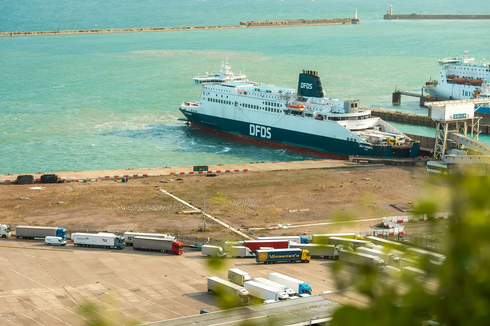 A ferry docked at a Ro-Ro port with trucks lined up to board