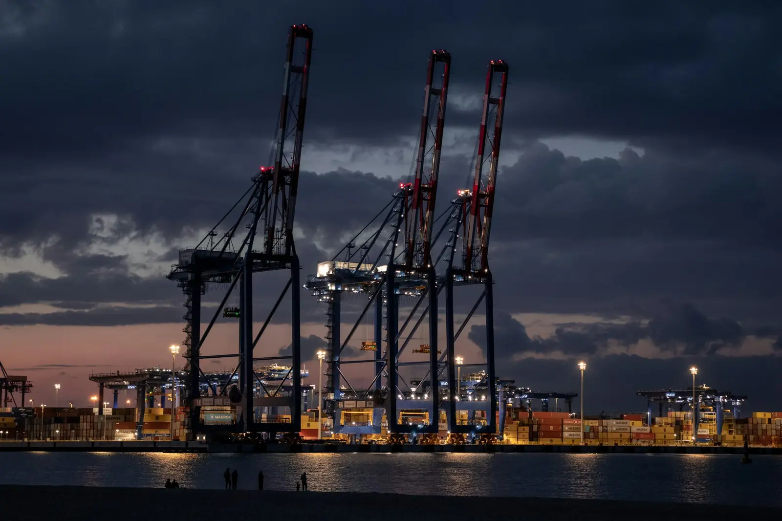 Container cranes at a port terminal at dusk