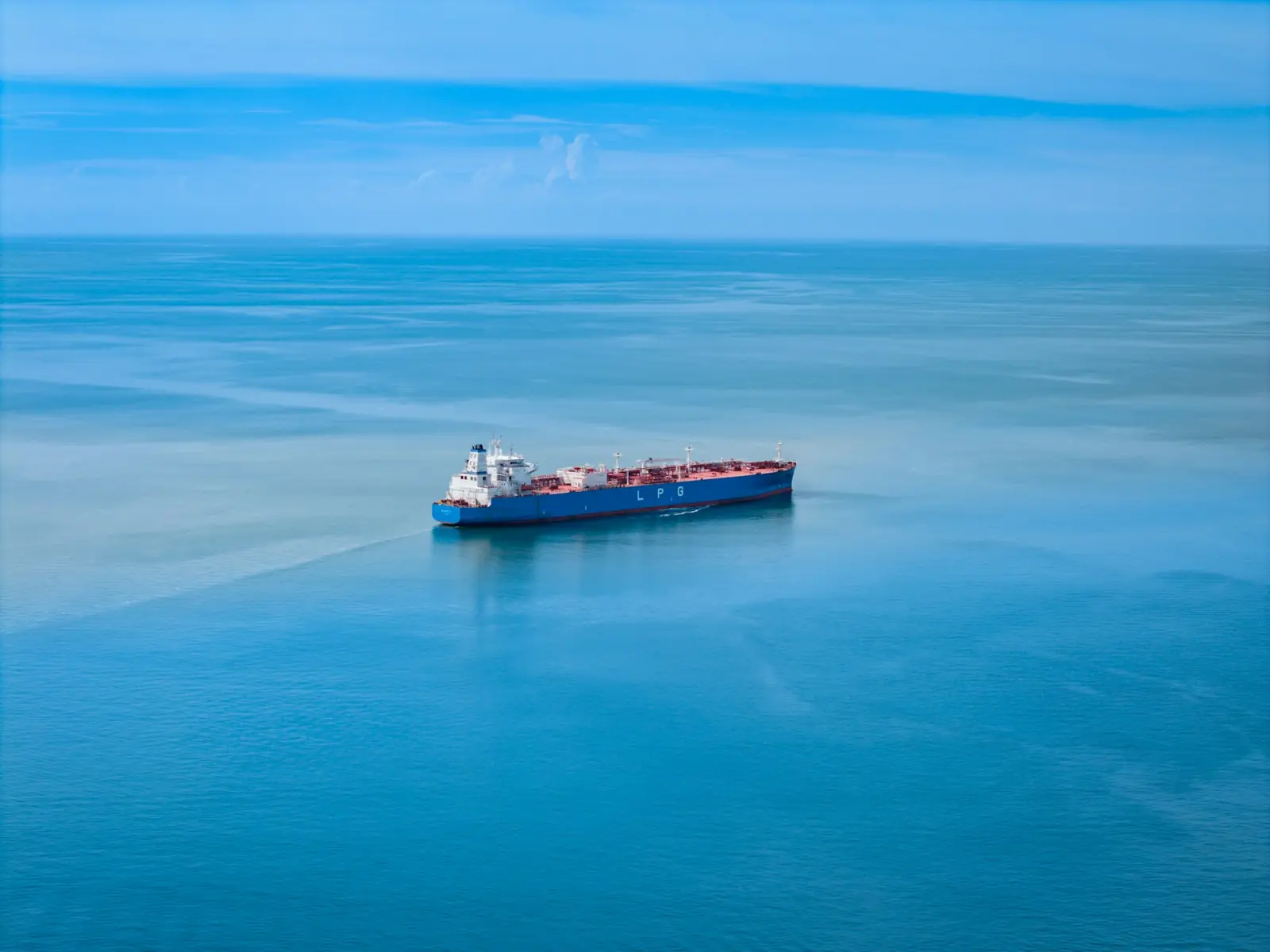 A cargo vessel sailing on calm blue water