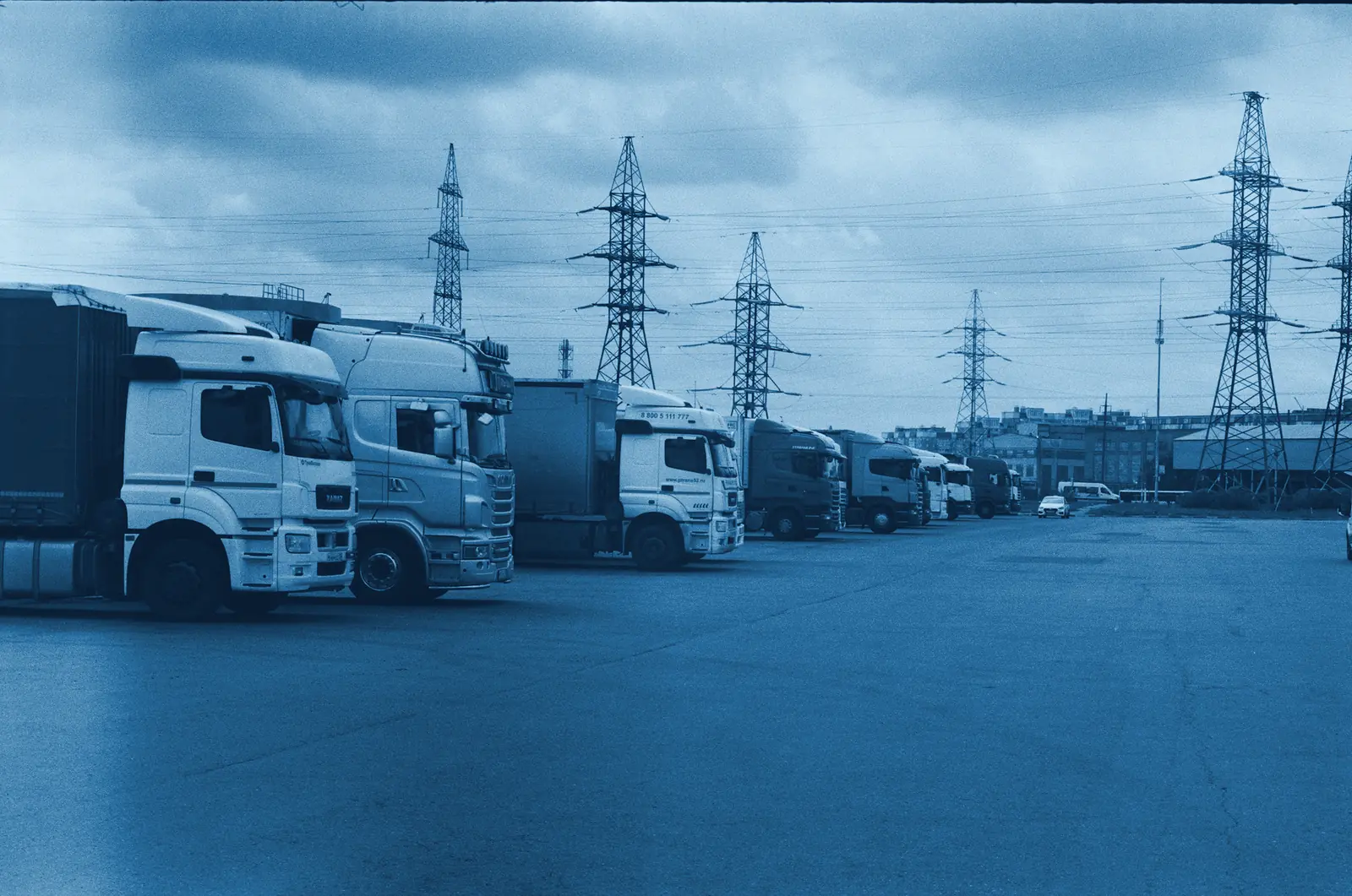 A row of trucks parked at a logistics yard
